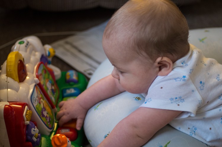 Micah plays with his toy